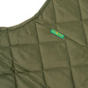 A close up of a DICKIES VINCENT ALVAREZ QUILITED VEST MILITARY GREEN with a tag on it.