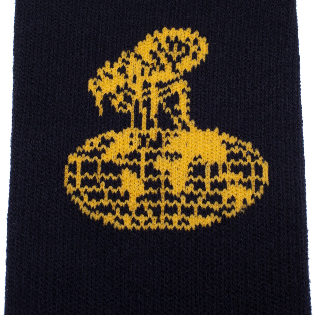 The FUCKING AWESOME FLEA SOCK BLACK / GOLD features a gold abstract emblem knitted onto black cotton fabric for a bold, eye-catching look.