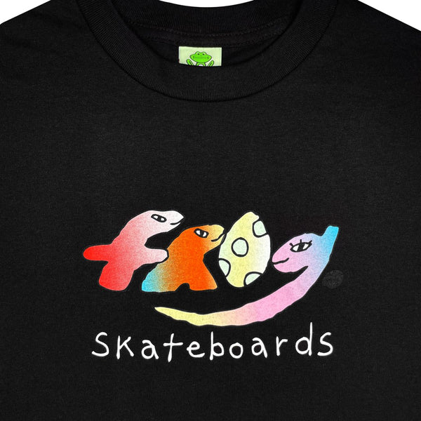 FROG DINO TEE BLACK, a black tee by FROG, features a colorful, stylized "frog" text logo with the word "Skateboards" underneath.