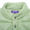 A jade colored FUCKING AWESOME DILL PUFFER JACKET with a purple label on it.