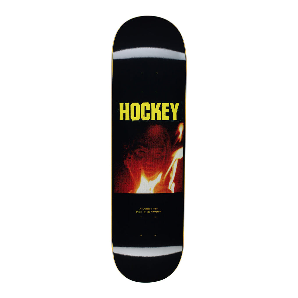 A skateboard with a face and fire image. 