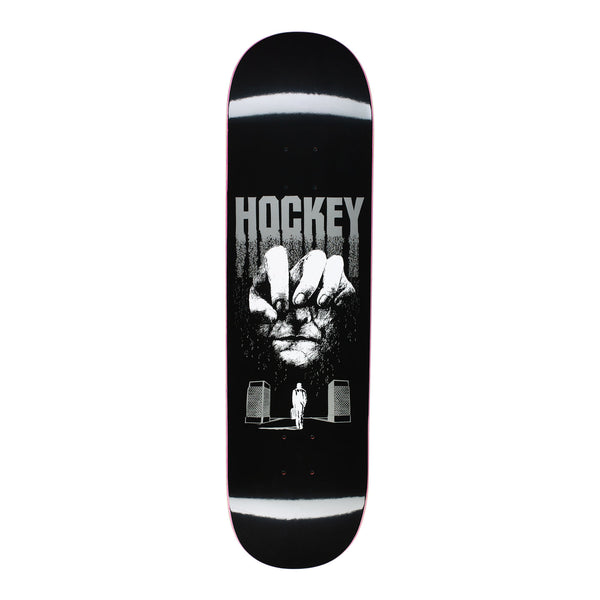 A black skateboard deck with a face and a hand.