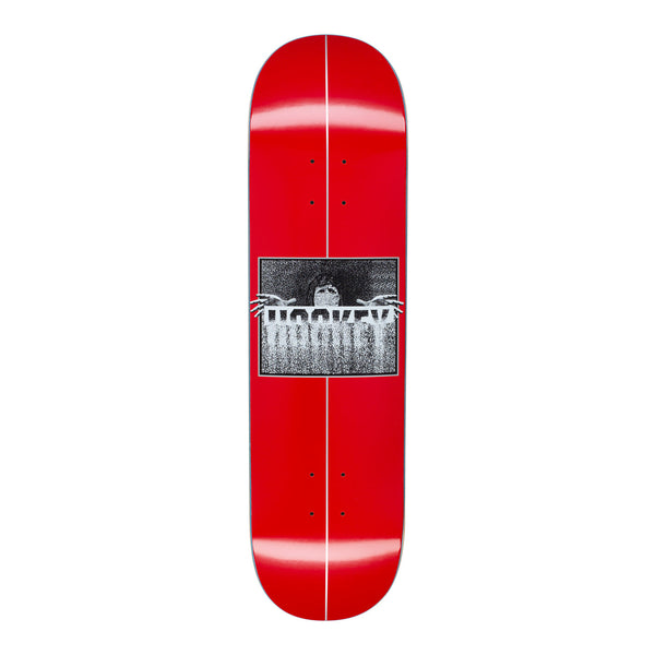 A red skateboard with a blurry person and the blurry word HOCKEY.