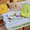 A bunch of BLUETILE fresh produce sticker packs sitting on top of a box.