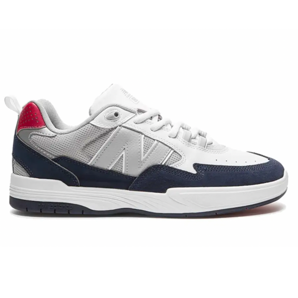 A NB NUMERIC 808 TIAGO white and blue sneaker with a red sole.
