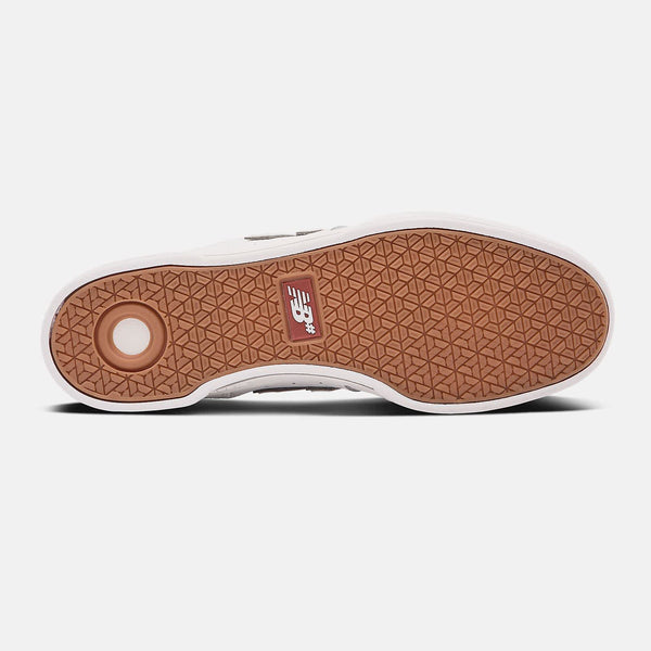 A white and brown NB NUMERIC 288 SPORT JACK CURTIN WHITE / GREY skate shoe on a white surface.