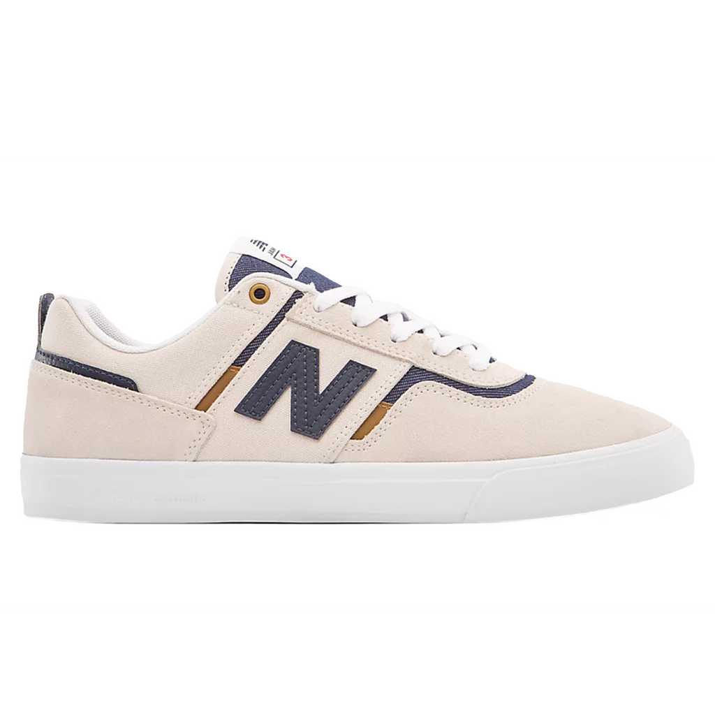 a NB Numeric Foy 306 white/navy sneaker with a blue and gold stripe on the side.