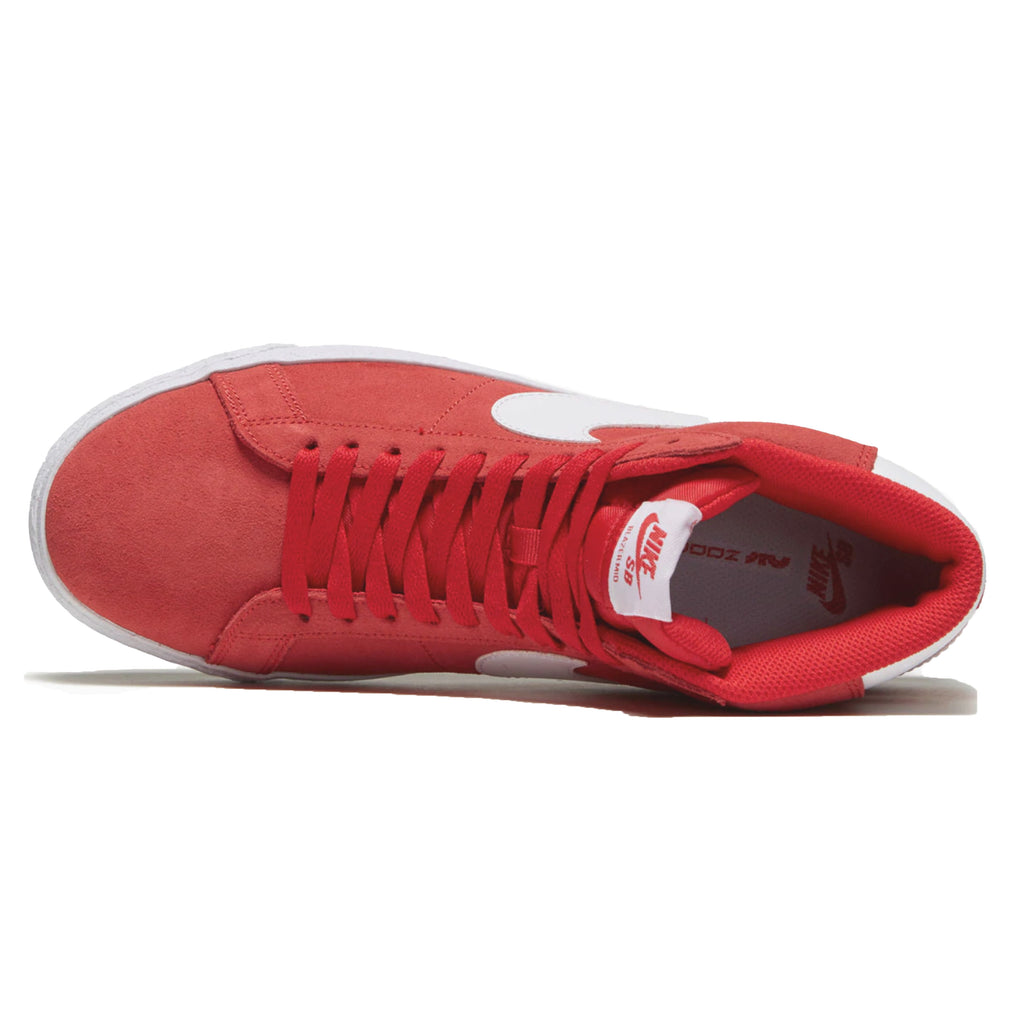 A pair of Nike SB Blazer Mid University Red/White sneakers.
