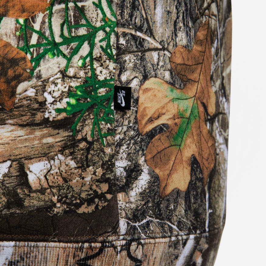 A close up of a Nike SB x Realtree® Fleece Allover Camo Hoodie with a leaf on it.