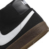 A black and white Nike SB Blazer Mid sneaker with a brown sole.
