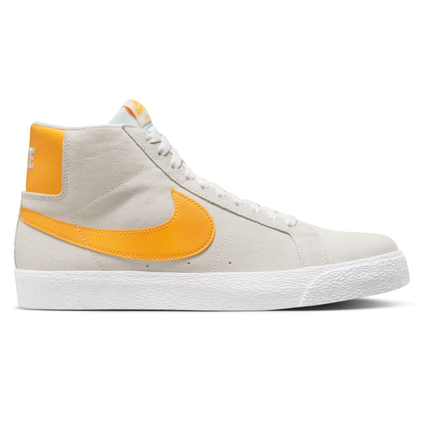 A pair of white and yellow Nike SB Blazer Mid Summit White / Laser Orange sneakers.