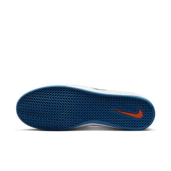 Bottom view of a white nike NIKE SB ISHOD PRM ORANGE / BLUE JAY sneaker with a blue textured rubber sole and orange Nike logo near the heel, photographed at BLUETILE SKATEBOARDS in Columbia, SC.