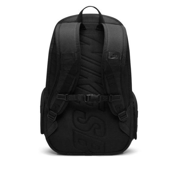 The nike NIKE SB RPM BACKPACK BLACK is shown from the back, featuring padded shoulder straps, a chest buckle, and "SB" lettering embossed on its water-resistant back panel.