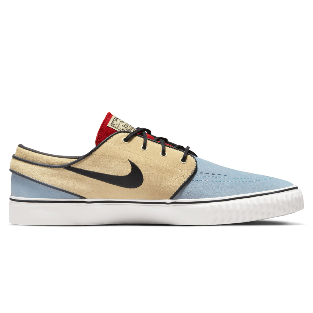 A blue and beige nike shoe with a black and red shoelace, specifically the NIKE SB ZOOM JANOSKI OG+ ALABASTER / CHILE RED.