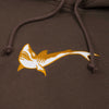 A yellow and white shark graphic appears on brown fabric with visible drawstrings, showcasing the bold style of the nike SB OSKI Orange Label Hoodie Brown.