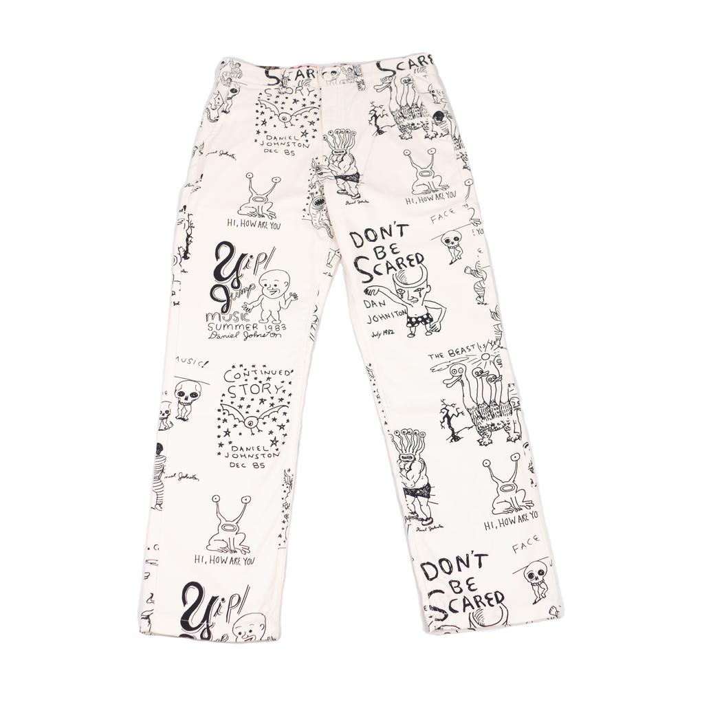 An authentic white VANS X DANIEL JOHNSTON AUTHENTIC CHINO LOOSE FIT pant with black and white drawings on it from DANIEL JOHNSTON x VANS collaboration.