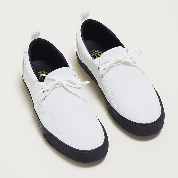 A pair of white dress style shoes with a black sole and insole