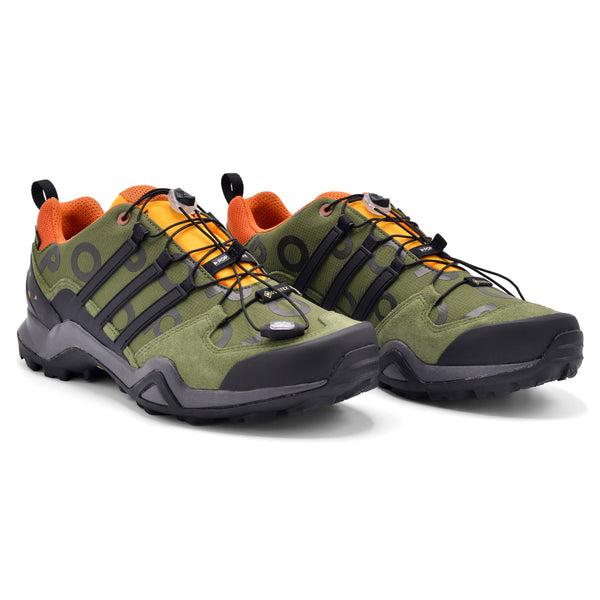 A pair of ADIDAS X POP TRADING CO. POP SWIFT R2 GTX green and orange shoes.