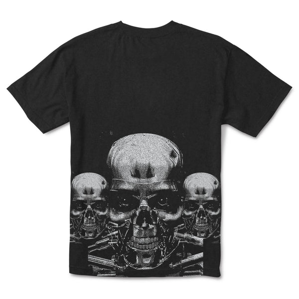 The PRIMITIVE X TERMINATOR 2 Terminator Tee in black showcases a detailed metallic skull graphic with two smaller skulls in the background, reminiscent of the Terminator aesthetic.