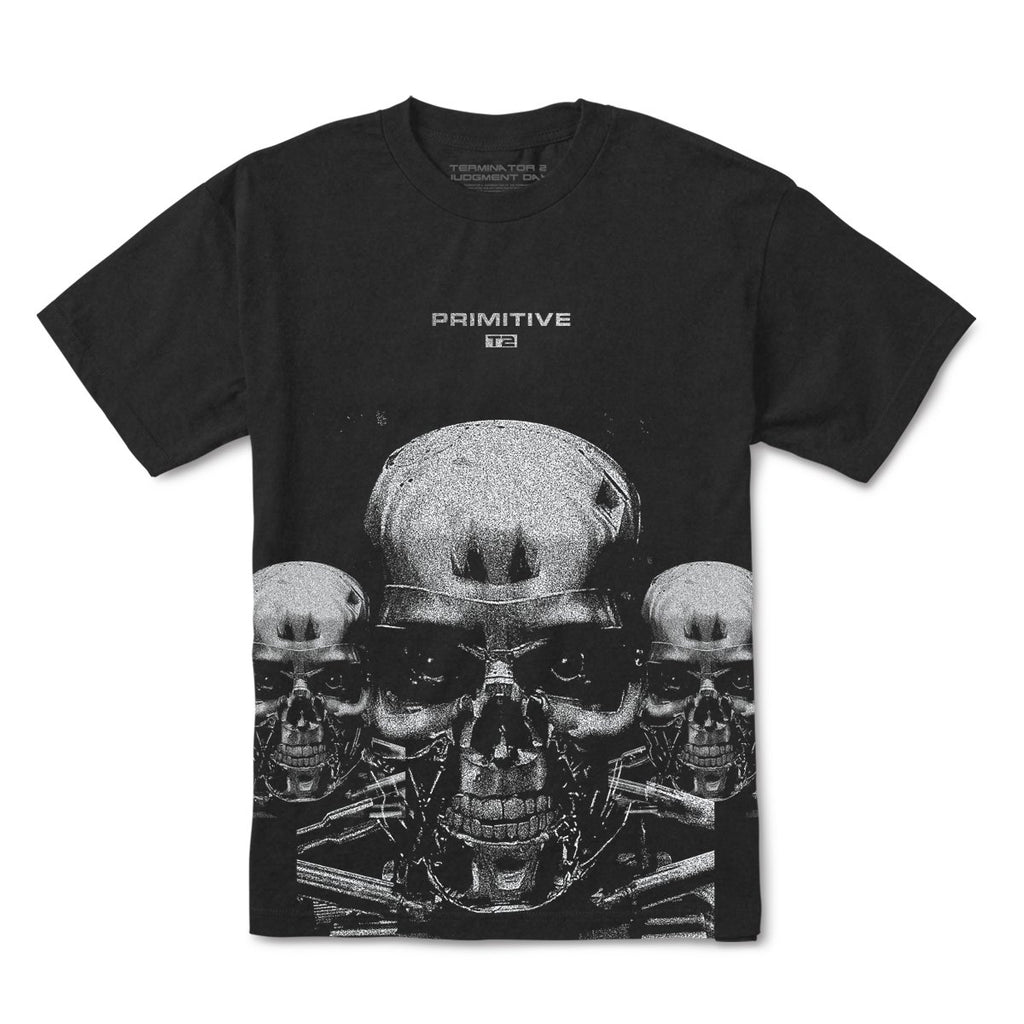 Black tee by Primitive, featuring a graphic of three metallic-toned skulls with the word "PRIMITIVE" above the central skull. This design is part of the PRIMITIVE X TERMINATOR 2 TERMINATOR TEE BLACK collection.