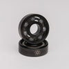 A pair of QUANTUM ISOTOPES CERAMIC HYBRID BEARINGS, known for their high tensile strength, featured on a white background. (Brand Name: Quantum Bearings)