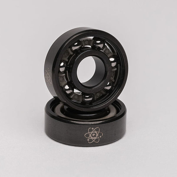 A pair of QUANTUM METALLIC SERIES BEARINGS from Quantum Bearings, showcasing stability and mechanical strength, set against a clean white background.