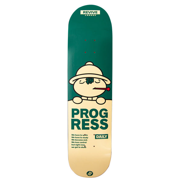 The REVIVE X PROGRESS DAILY SAFARI skateboard features a green top and a beige bottom adorned with a cartoon character and the text "PROGRESS DAILY." Additional smaller text, including "REVIVE X PROGRESS" and JOHN HILL, is located at the bottom of the skateboard.