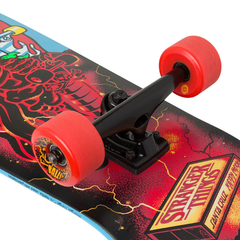 A SANTA CRUZ skateboard with red wheels and a dragon on it.