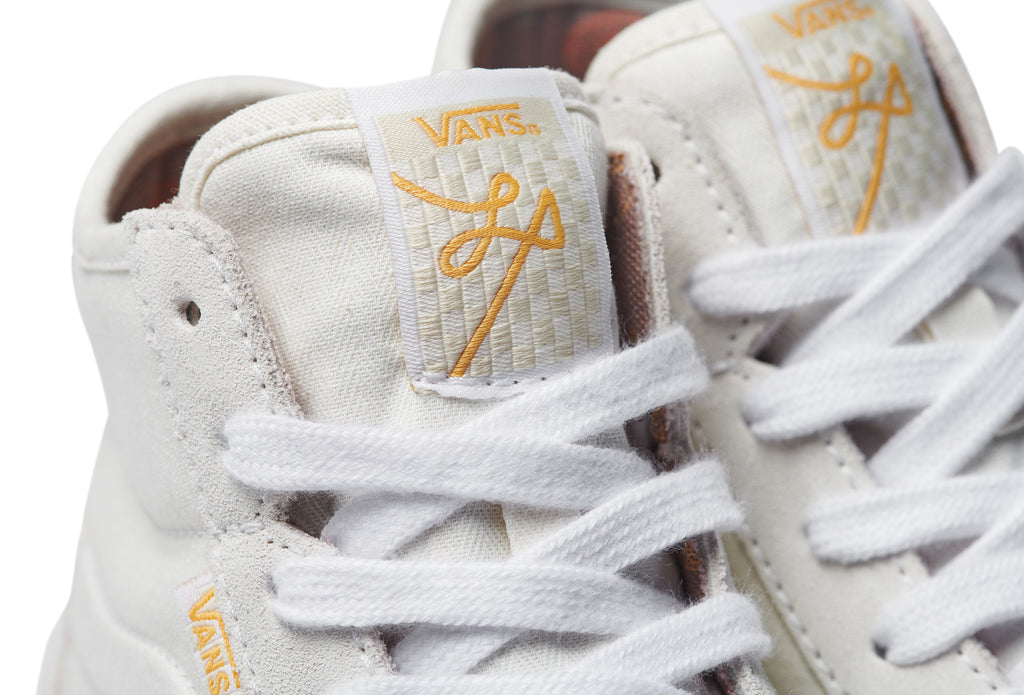 Vans The Lizzie Marshmallow sneakers in white and gold, known for their durability and performance.