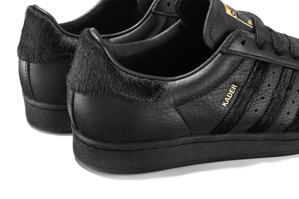 The ADIDAS KADER SUPERSTAR CORE BLACK / CORE BLACK in Core Black is also available in a stunning gold color.
