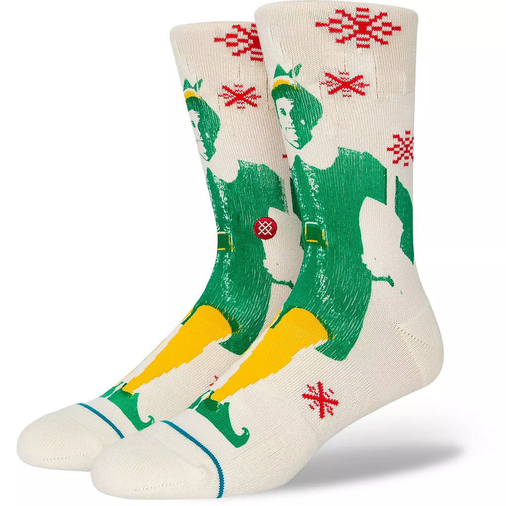 A pair of STANCE socks with a printed illustration of Buddy The Elf and off white snowflake patterns.