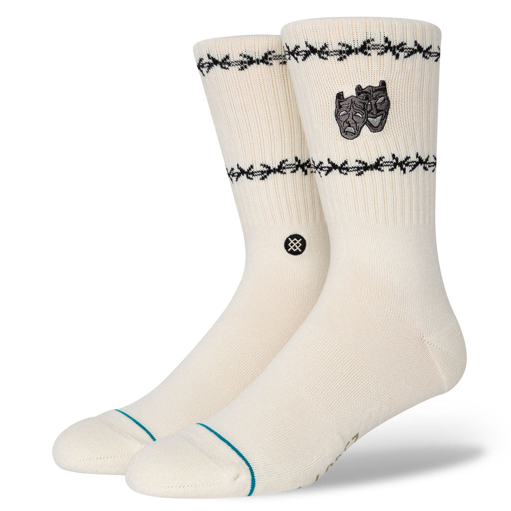 A pair of STANCE SOCKS LOUIE LOPEZ OFF WHITE LARGE with black decorative patterns at the cuffs and a small Stance emblem on the side.