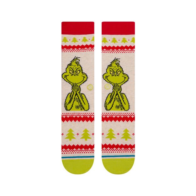 A pair of festive Stance socks featuring the Grinch character with a Christmas-themed pattern.