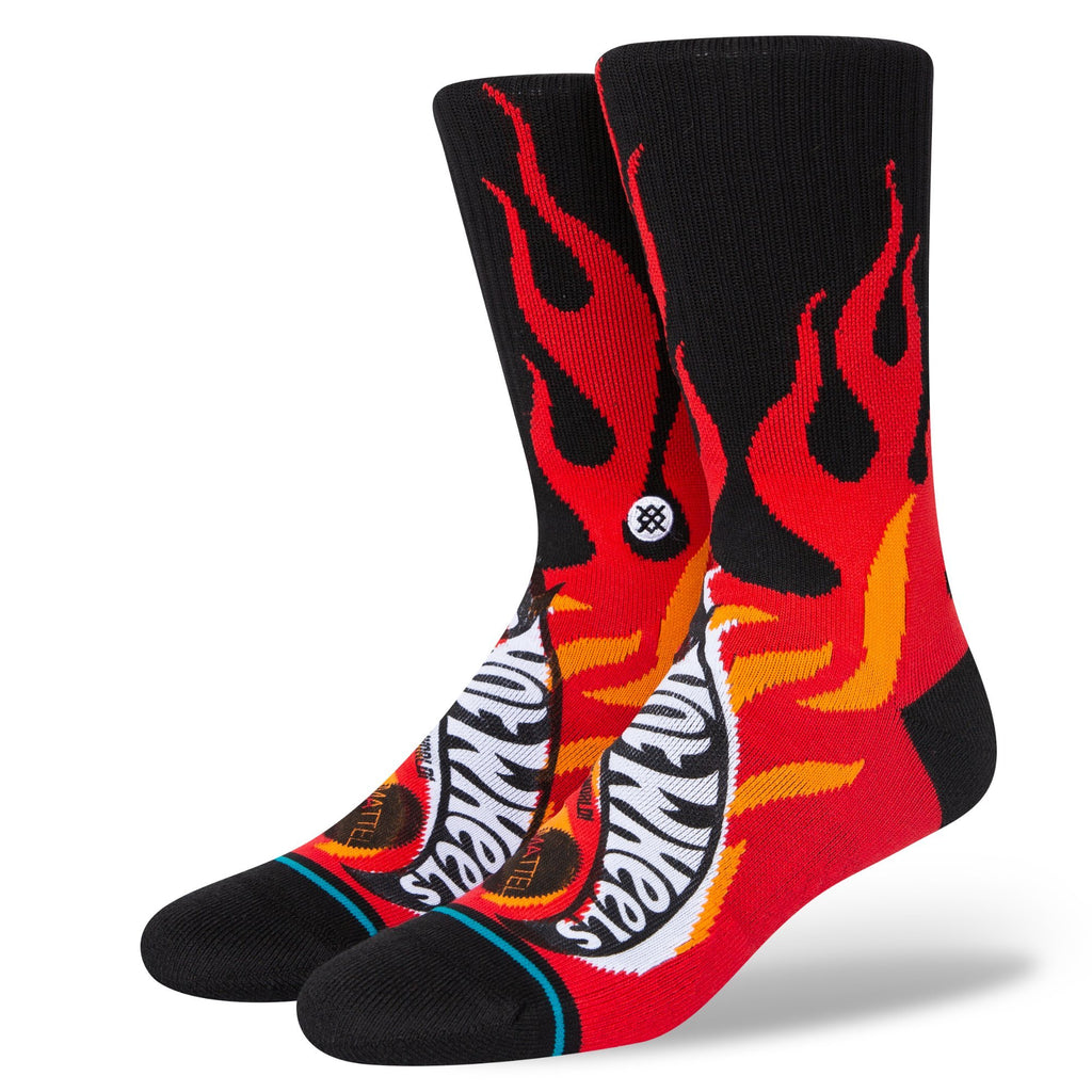 A pair of black large STANCE socks with a red and yellow Hot Licks pattern and white accents on a white background.