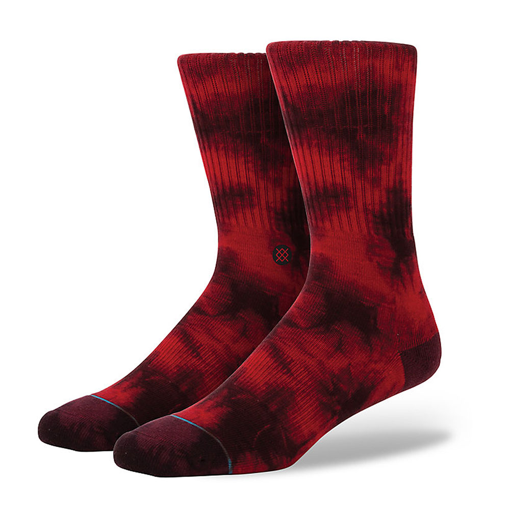 A pair of red large and black patterned STANCE NOSTEN CREW socks against a white background.
