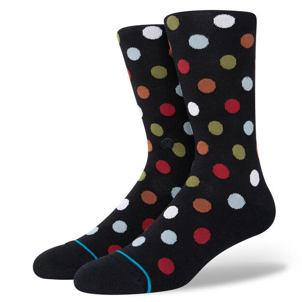A pair of STANCE socks with black and multi colored dots.