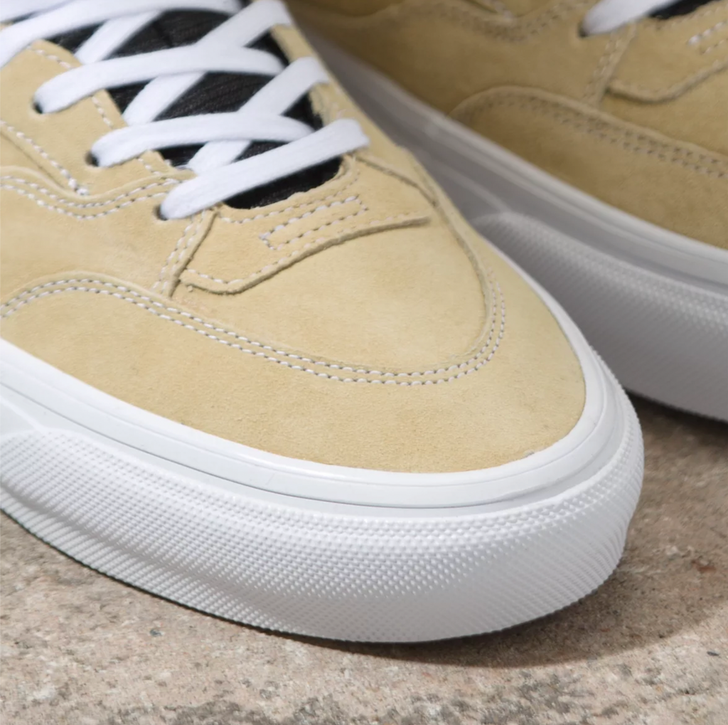 A close up of VANS SKATE HALF CAB TAUPE shoes on a stone surface.