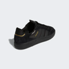 A black and gold ADIDAS TYSHAWN LOW BLACK / BLACK / GOLD sneakers.