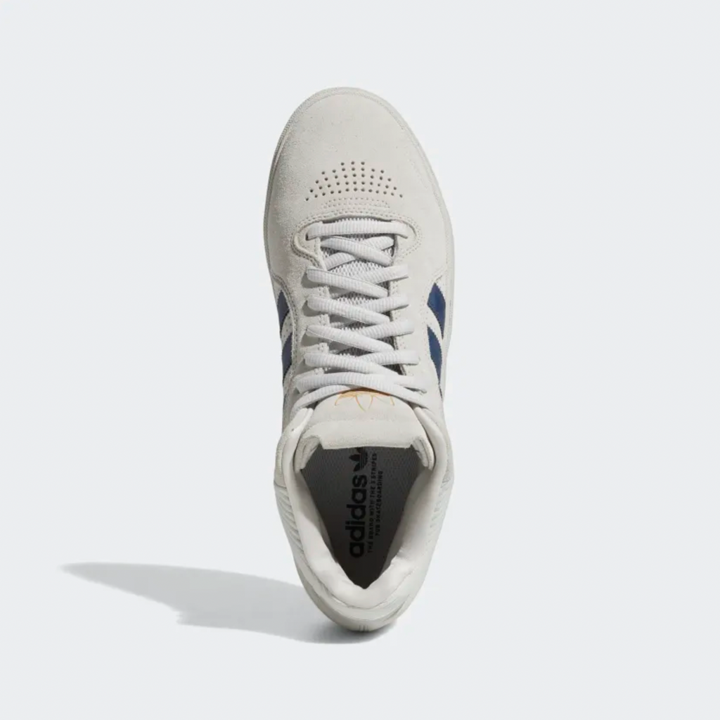A pair of white and blue ADIDAS TYSHAWN shoes on a white background.
