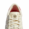 A pair of white ADIDAS PUIG INDOOR sneakers.