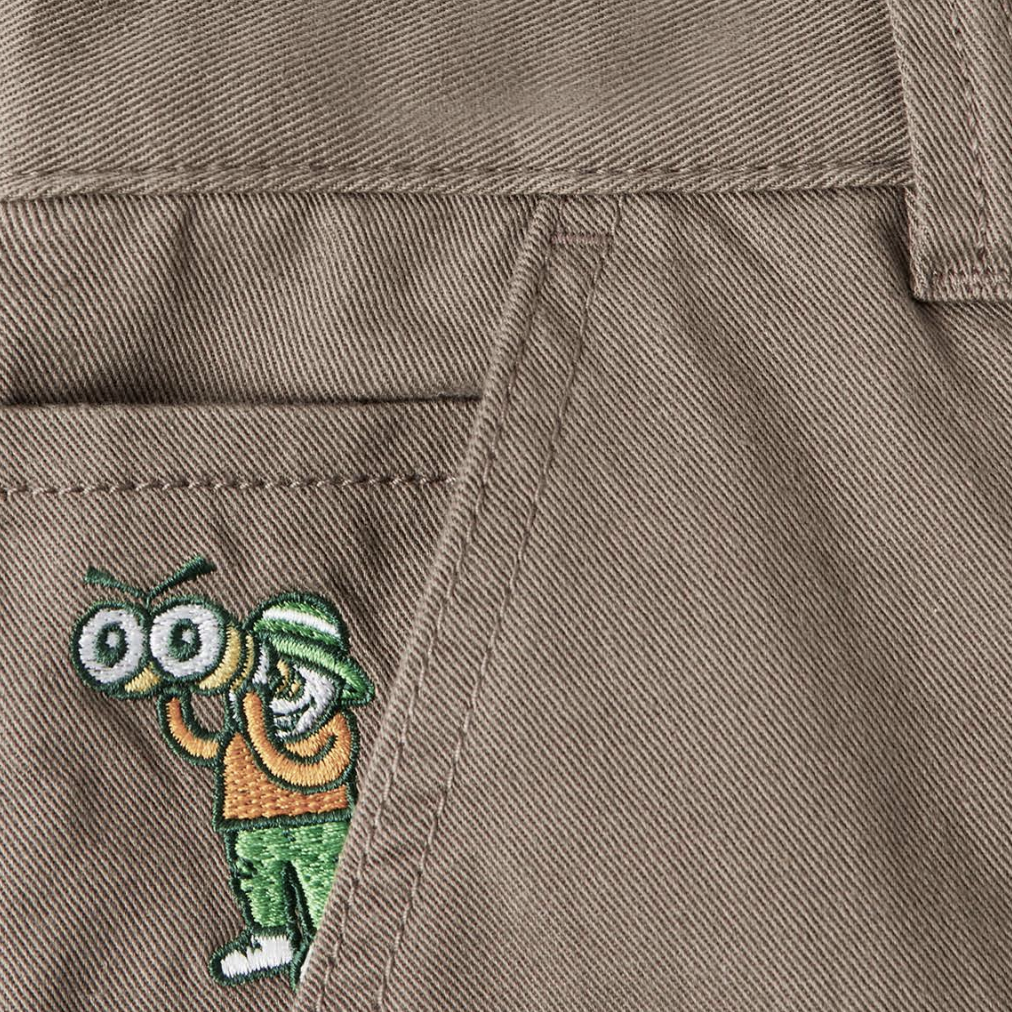A close up of a person's POLAR '93! CARGO KHAKI pants with a cartoon character on it.