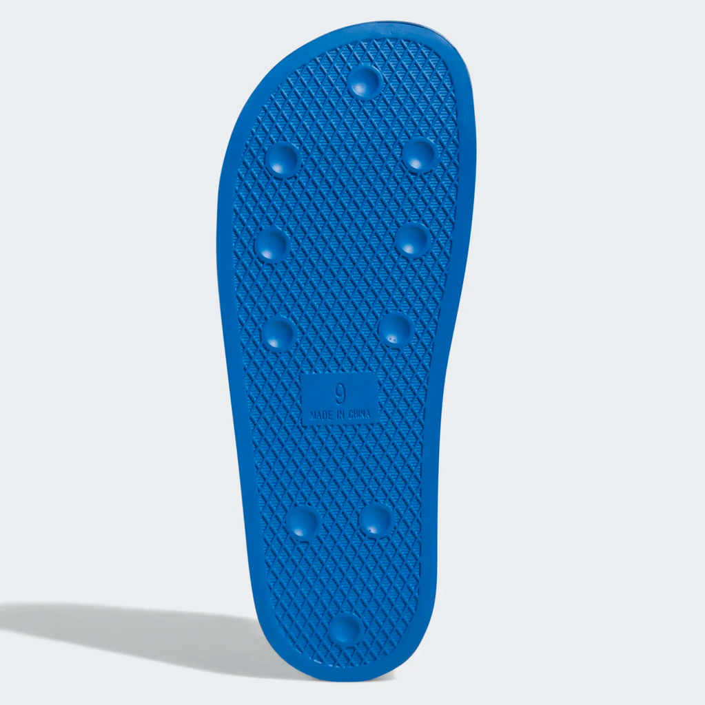 The sole of an ADIDAS SHMOOFOIL BLUE BIRD / WHITE shoe on a white background.