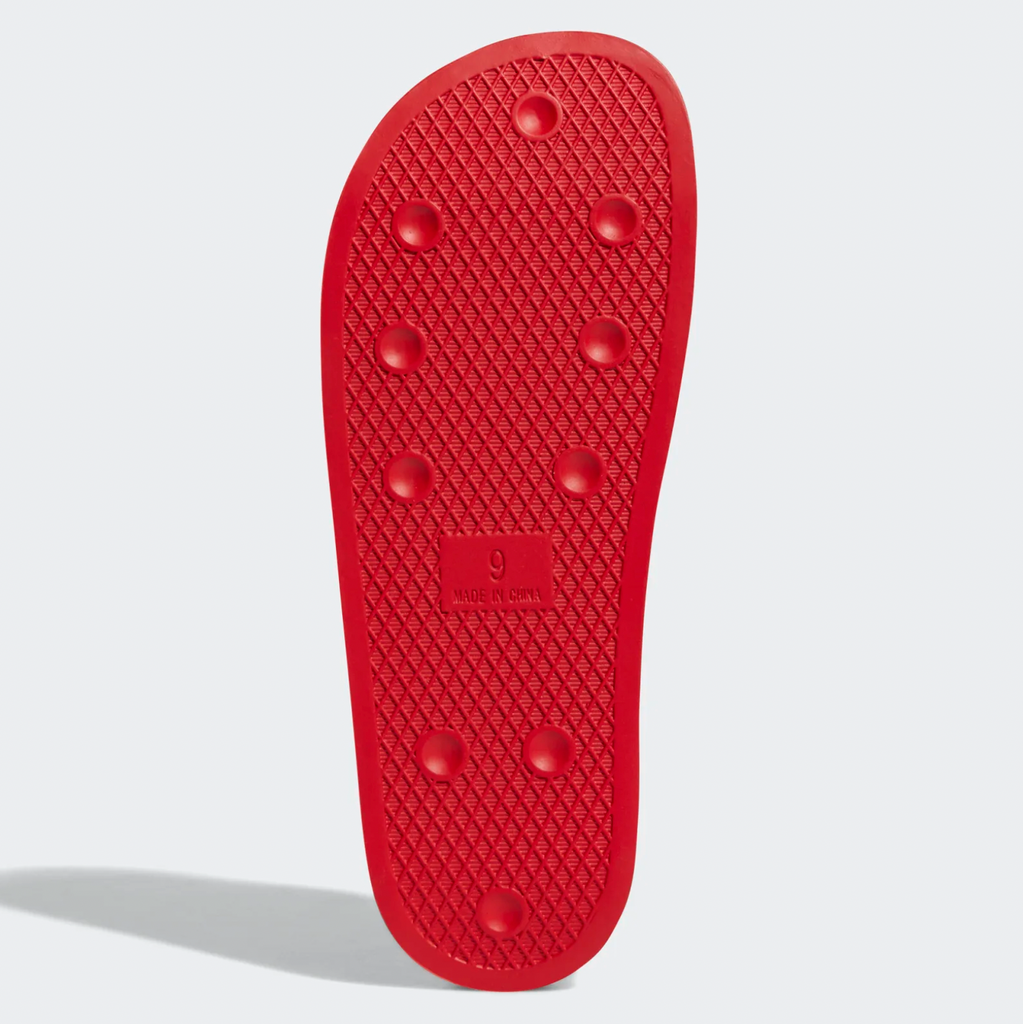 The sole of an ADIDAS SHMOOFOIL SCARLET / WHITE shoe on a white background.