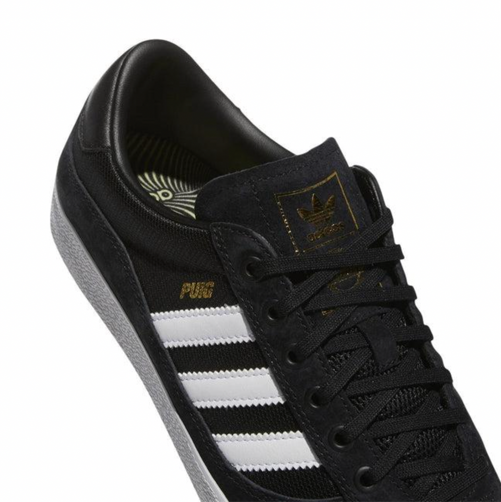 A black and white ADIDAS PUIG INDOOR sneakers.