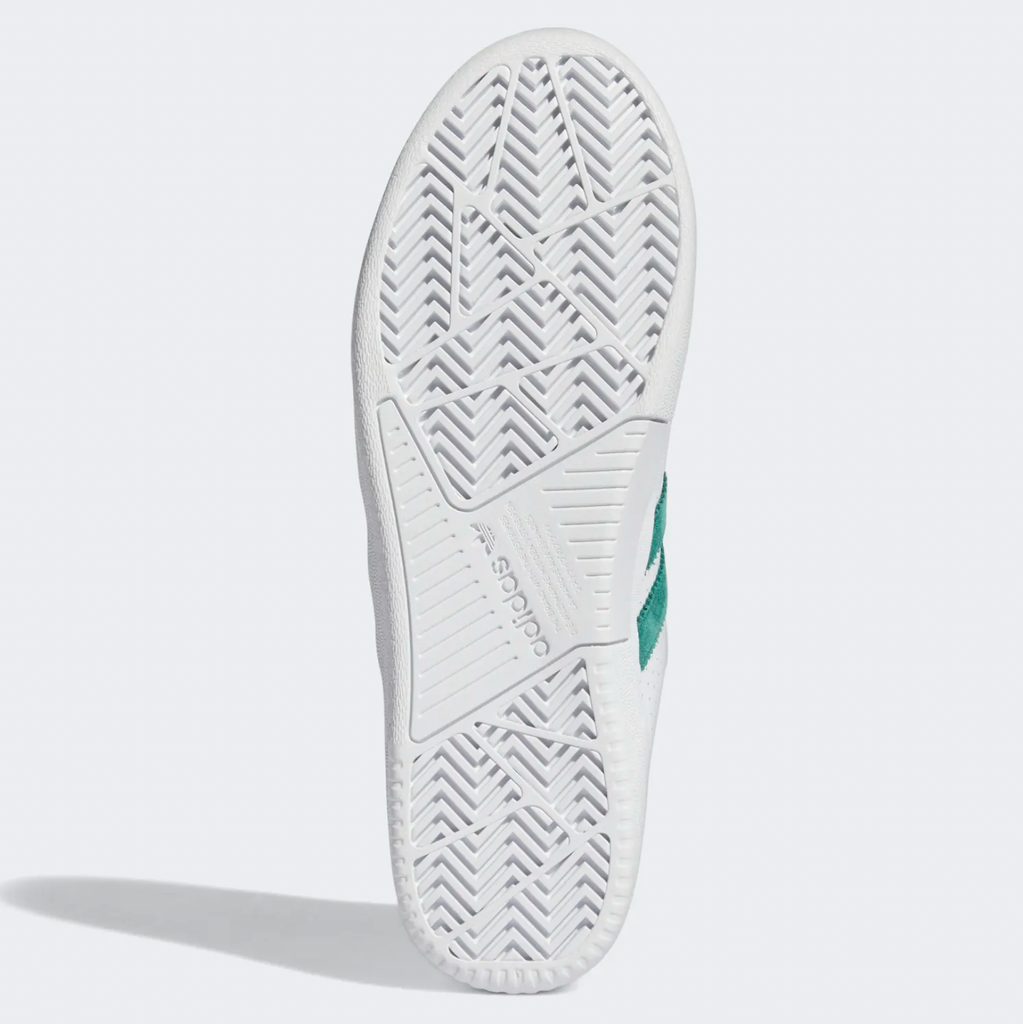 An ADIDAS TYSHAWN LOW FLAT WHITE / COLLEGIATE GREEN / METALLIC GOLD tennis shoe.
