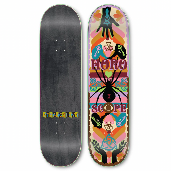 Two skateboard decks are shown. The left deck is plain with "Strangelove" written in the center. The right deck, named "STRANGE LOVE AARON ROSE SAD GIRLS" and designed by Aaron Rose, features a colorful, symmetrical design with the word "Horoscope" along with various symbols and hands.