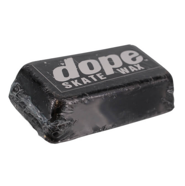 A large rectangular brick of black skateboard wax, labeled "DOPE SKATEBOARD WAX LARGE BRICK BLACK" in white text with the brand name "DOPE WAX," and wrapped in clear plastic.