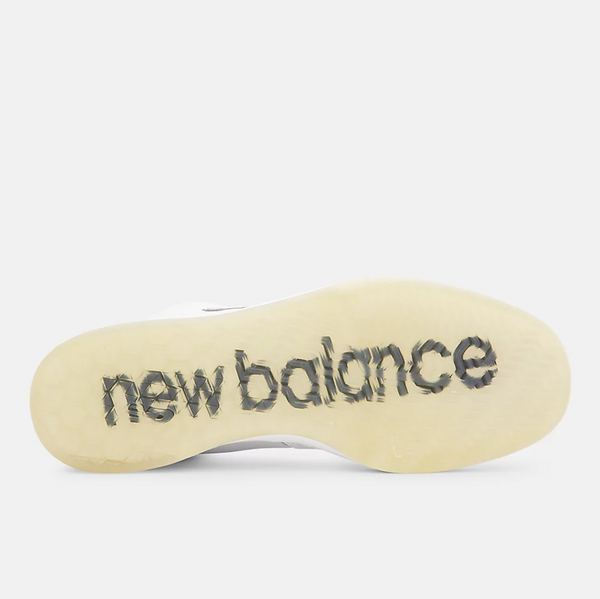 A close up of NB NUMERIC 440 WHITE / WHITE with the word NB NUMERIC on it.