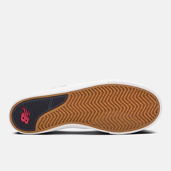 a pair of NB NUMERIC FOY 306 WHITE / NAVY shoes with red soles.