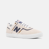 A NB Numeric Foy 306 white/navy shoe with a blue and gold stripe on the side.